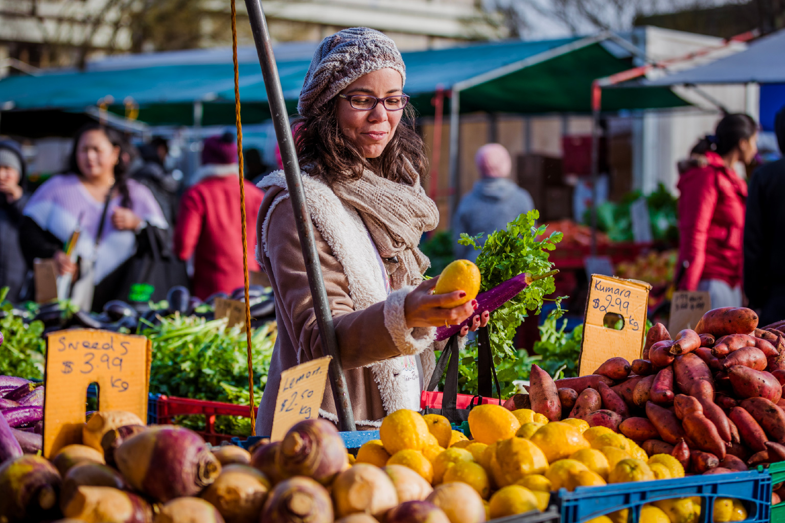 Person holding lemon at market