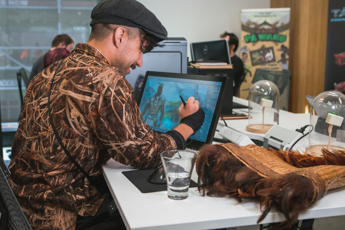 Māori man working at a computer